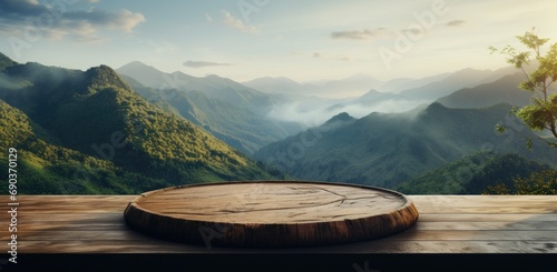 a wooden circular table overlooking some grassy mountains