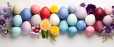 colorful easter eggs in rainbow, floral arrangement, and white background
