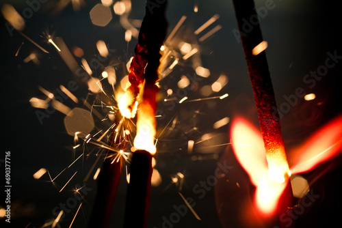 Festive Sparklers Igniting in the Dark, Close-Up Perspective