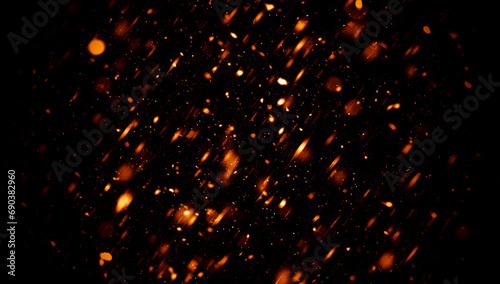 Blurred fire embers sparks on black background . Texture isolated overlays. Concept of particles, sparkles, flame and light. photo