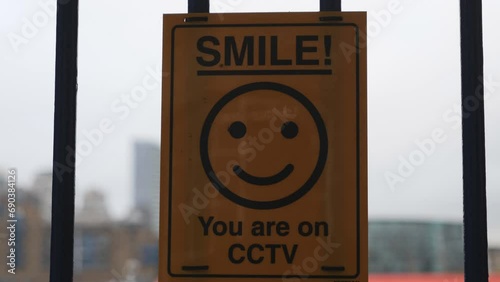 A sign with a smiling emoji that says 'Smile! You are on CCTV'.
