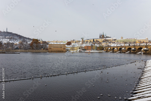Snowy Prague Lesser Town with Prague Castle and Charles Bridge above River Vltava in the sunny Day , Czech republic © Kajano