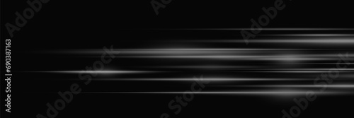  Flash of light and glare. Line of speed of dynamic movement of light. On a black background.