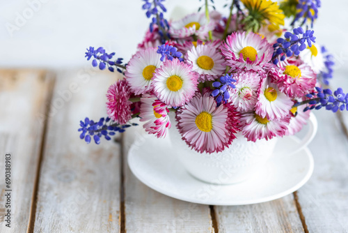 Colourful floral composition for Mother's or Women's day, anniversary, birthday. Summertime inspiration. Greeting holiday card template with summer fresh bright daisy flowers in a white porcelaine mug