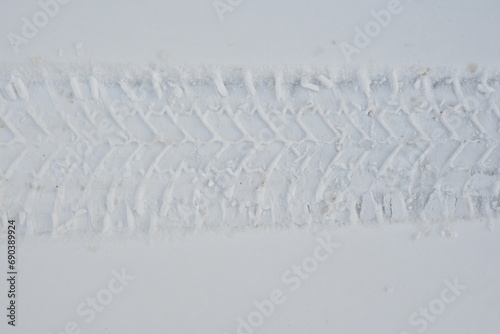 Fototapeta Naklejka Na Ścianę i Meble -  car tyre tracks, tread texture on snow, snow texture, white snow surface 
