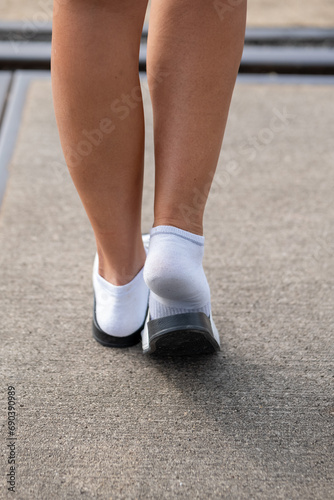 a woman with white socks and sandals in summer