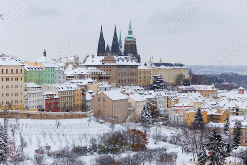 Snowy Prague City with gothic Castle from the Hill Petrin, Czech republic