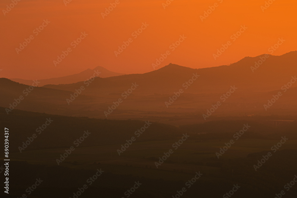 Fantastic sunset view in mountains of central Bohemia. Sky colors paint hypnotic scenery out of this world. More like a landscape from Mars.