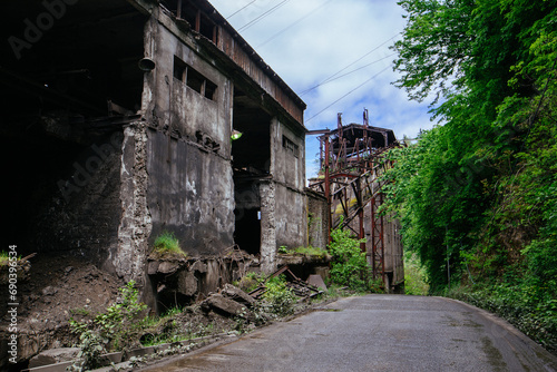 Old ruined overgrown industrial building in Chiatura, Georgia © Mulderphoto