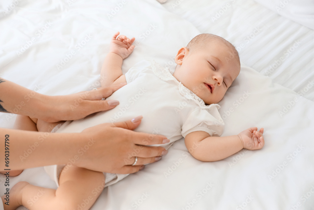Mother with her little cute baby sleeping in bedroom at home Mother with her little cute baby sleeping in bedroom at home