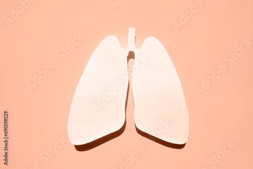 Anatomical lungs paper silhouette. The concept of healthy breathing. Flat lay. Peach fuzz is color of year 2024.