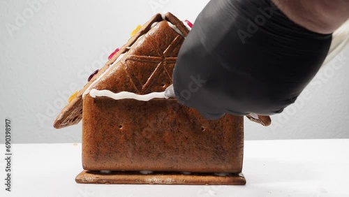 Christmas gingerbread in the shape of a house. Assembling a gingerbread house before Christmas with sugar icing.