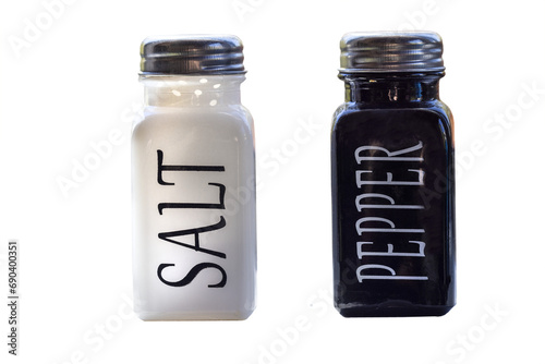 White and black ceramic bottles of salt and pepper with metal screw top lids