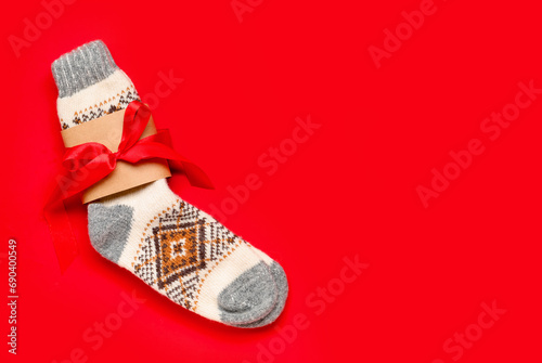 Christmas knitted socks on red background