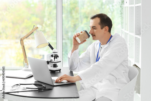Male doctor with coffee cup...