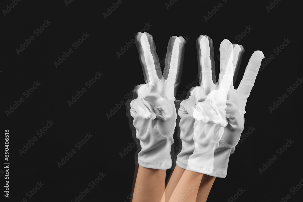Stroboscopic photo of moving woman showing victory gesture on dark background Stroboscopic photo of moving woman showing victory gesture on dark background