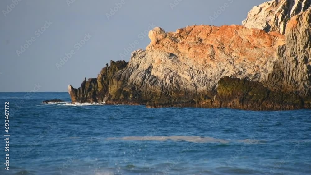 Slow motion video of the waves breaking on the rocks of the beach cliffs. Slow motion video of the waves breaking on the rocks of the beach cliffs.
