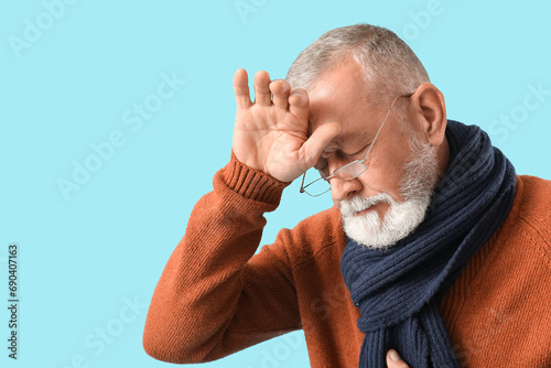 Sick mature man on blue bac...