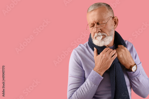 Sick mature man on pink bac...