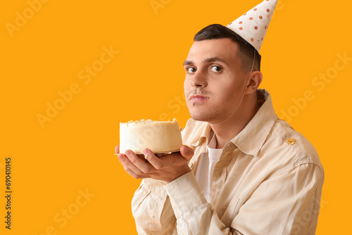 Young man in party hat with...