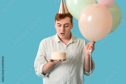 Young man in party hat with...