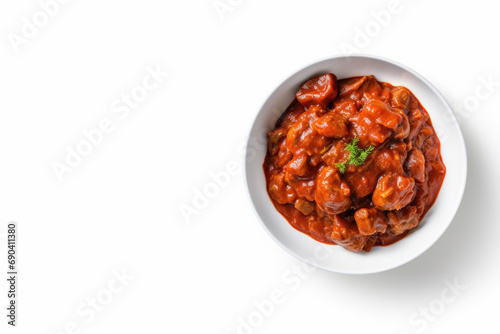Flay lay of ragout, goulash or stew with meat, sauce and vegetable on white background, copy space