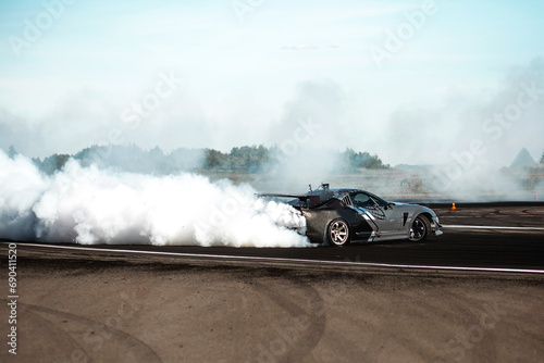 Obraz na plátne Blurred car drifting, Professional driver drive car drifting on asphalt street r