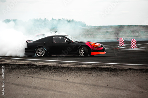 Adrenaline sport scene car drifting in carpark with lot of smoke from burning tire © AvokadoStudio