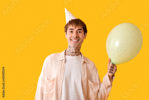 Young man in party hat with...