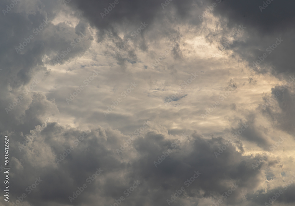 The sun's rays passing through the clouds and shining form an interesting light pattern against the sky. Space for text, Selective focus.