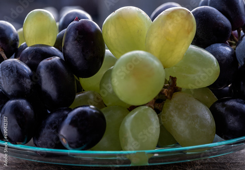 Close-up of Fresh Green seedless and Black seedless Grapes. grapes healthy fruit ready to eat, Copy space, Selective focus.