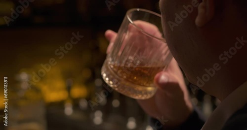 Man drinks alcohol close-up. Glass of whiskey. Enjoy fine alcoholic drinks beverage. Close up