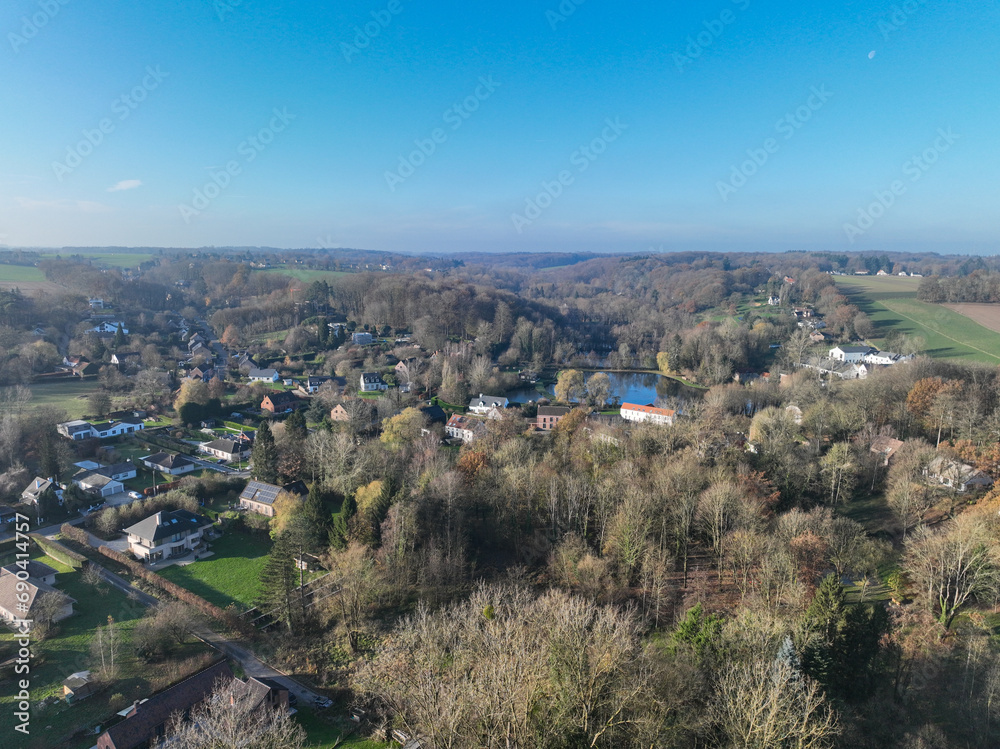 Aerial view of houses surrounded by forest and farmland in the country side area of Walloon, Belgium, Europe Aerial view of houses surrounded by forest and farmland in the country side area of Walloon, Belgium, Europe
