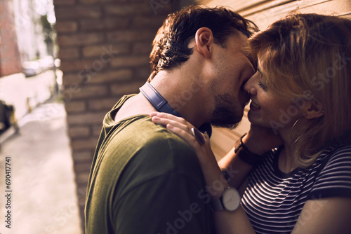 Romantic young couple kissing in the city photo