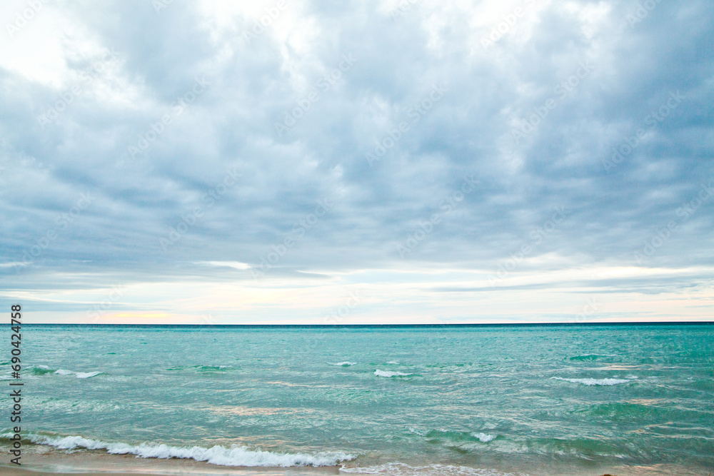 Tranquil Lake Michigan Beachscape with Gentle Waves and Cloudy Sky Tranquil Lake Michigan Beachscape with Gentle Waves and Cloudy Sky