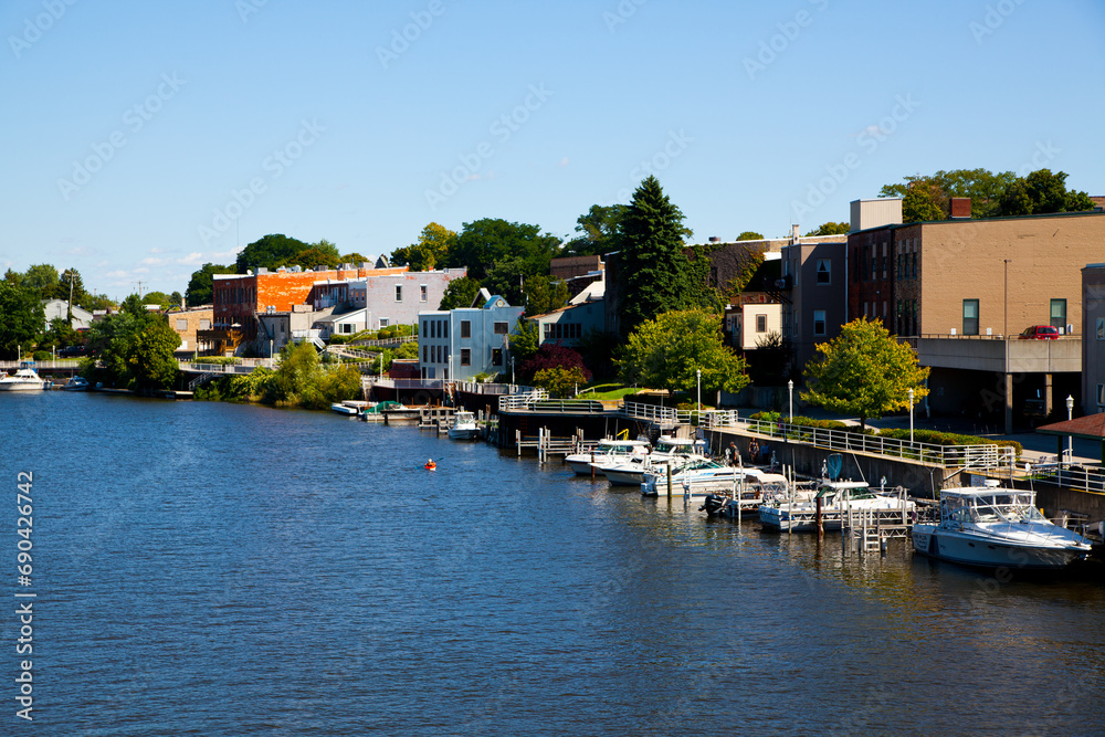 Elevated View of Riverside with Docked Boats and Colorful Buildings in Michigan