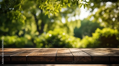Empty old wooden table with green nature background photo