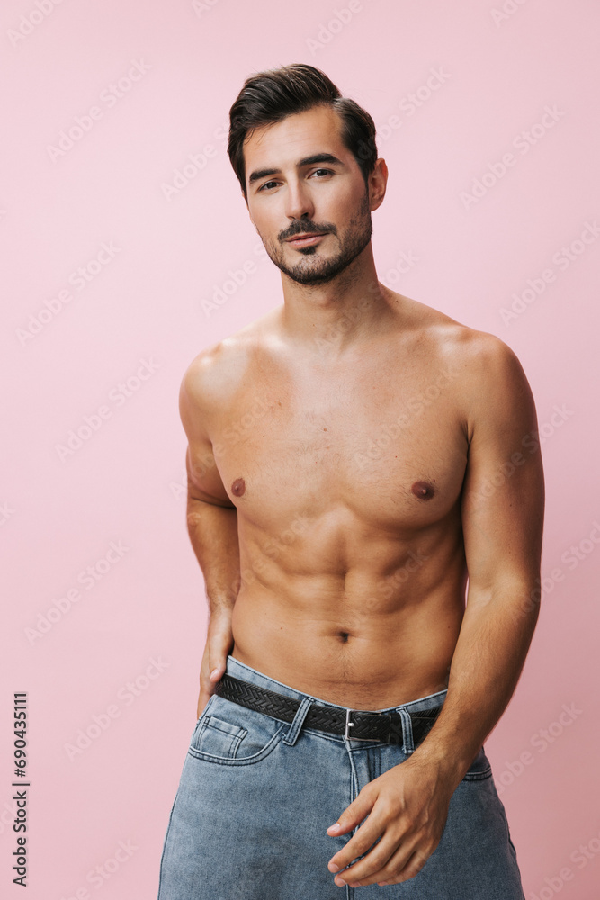 Fototapeta premium Naked man fitness torso background body belt pink lifestyle sexy jeans muscular sport muscle