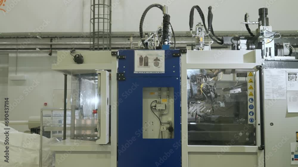 Manufacturing factory machine producing goods on the industrial conveyor line. Manufacturing factory machine working with material. Manufacturing factory machine inside the chamber. Manufacturing factory machine producing goods on the industrial conveyor line. Manufacturing factory machine working with material. Manufacturing factory machine inside the chamber.
