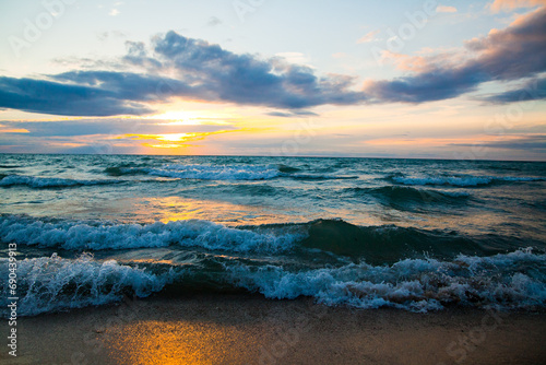 Tranquil Sunset Over Lake Michigan with Rolling Waves and Golden Glow