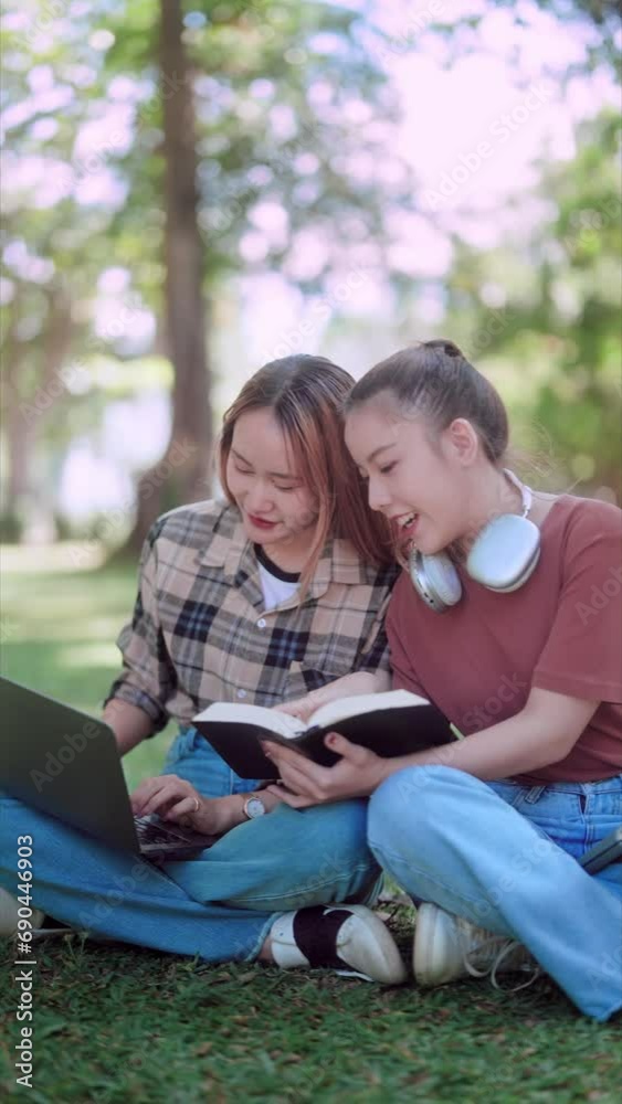 Asian female college student and her friends studying and researching content using laptops and textbooks under the trees in a garden, creating a refreshing outdoor study environment Asian female college student and her friends studying and researching content using laptops and textbooks under the trees in a garden, creating a refreshing outdoor study environment