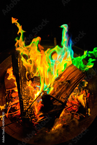 Vibrant Fire Pit Display with Green and Blue Flames in Outdoor Setting