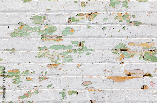 brick wall background with many layers ofin different color of old peeling paint photo