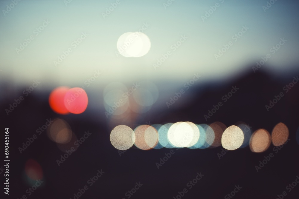 Colorful defocused bokeh abstract background created by city night lights. Blurred defocused colorful lights of traffic in the city. selective focus. - obrazy, fototapety, plakaty 