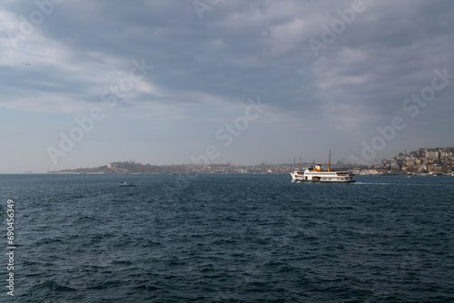 The waters of the Bosphorus Strait and the European part of Istanbul with the districts of Sulnatahmet and Beyoglu in the background on a sunny day, Istanbul, Turkey photo