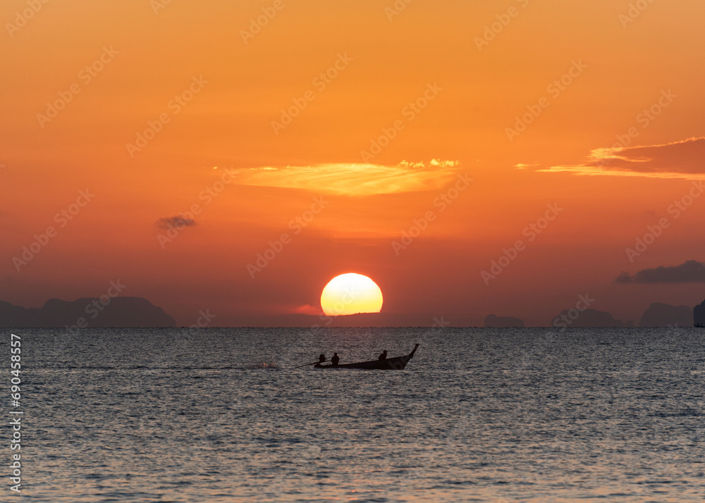 Beautiful sunrise in the sea and orange sky at Phuket city Beautiful sunrise in the sea and orange sky at Phuket city