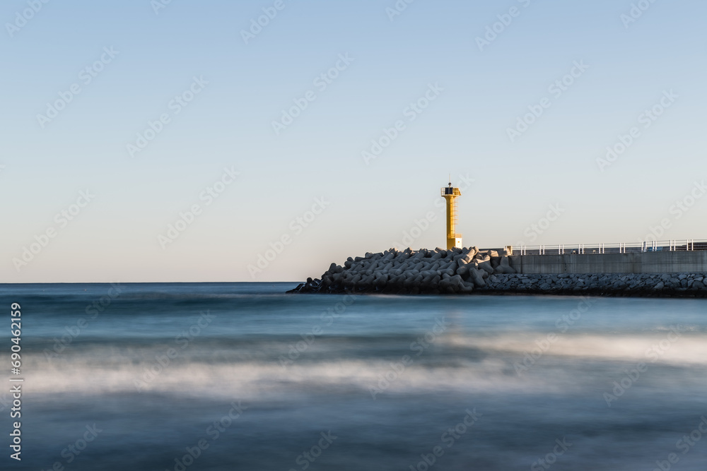 Beach scenery with a lighthouse and breakwater
Beach scenery with a lighthouse and breakwater