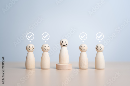 Wooden figures peg dolls stand above wooden podium among others with vote yes symbol. Open-mindedness, public hearing, elections. Volunteers, candidates, community representative.