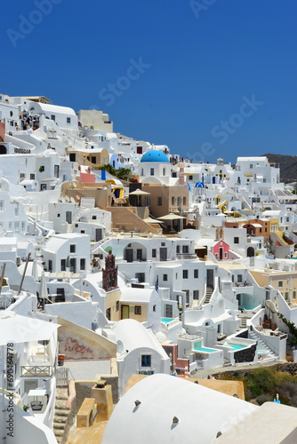 SANTORINI,GREECE-June 20 2023: Oia village, the most picturesque village on Santorini island, a famous touristic resort in the Cyclades islands, Aegean sea, Greece, Europe. This was on a hot sunny day © Scotts Travel Photos