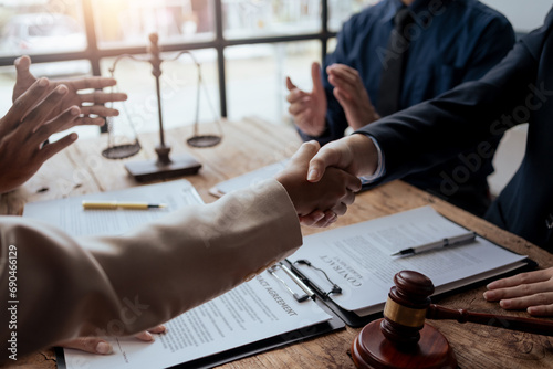 Businessman handshake to seal a deal with his partner lawyers or attorneys discussing a contract agreement.